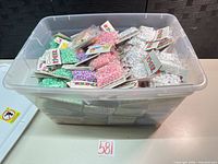 Large tub filled with sealed Pop Beads packs in assorted colors