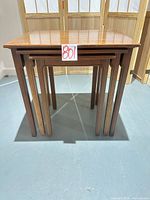 Front view of all three nesting tables stacked