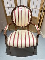 Front view of striped Louis XV-style armchair