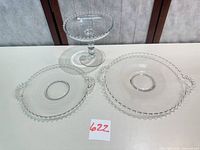 Full set showing cake stand and two handled plates