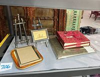 overall lot showing easels, small frames, gift-wrapped albums