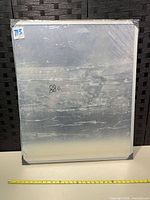 Front view of sealed whiteboard with tape measure for scale