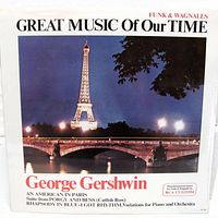 Front cover showing title, artist, series, Eiffel Tower image, sealed shrink