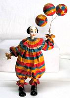 Full view of clown figurine front, displaying colors, balloons, costume, face