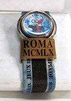 Front view of watch on strap showing dial and ROMA patch