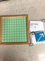 Board with green grid and rings of activity cards