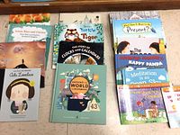 Assortment of books spread on floor showing multiple covers
