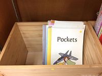 Stack of early reader booklets, top title Pockets