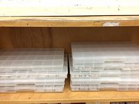 stacked clear organizer cases on shelf