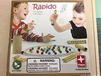 Box lid showing Hape Rapido branding, age and player information