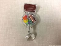 Front view showing clear housing, gears, copper coil, prism