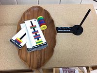 Full set displayed in a wooden tray showing pattern cards, stack of rings, base and rod
