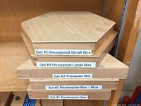 Stacked wooden boxes labelled Sets #1-#5