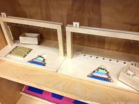 Both wooden frames, triangular racks, number tracks, and tile box displayed