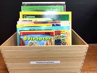 Wooden box containing assorted reptile and dinosaur books, label Reptiles/Amphibians visible