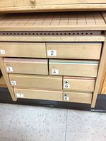 Closed cabinet front showing numbered drawers