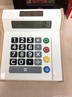 Front view of cash register showing keypad and LCD