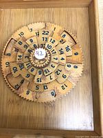 Top view of wooden puzzle in tray showing numbered gear layers
