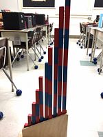 Full graduated red and blue rods displayed upright in wooden base