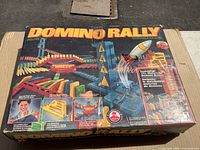 Front of Domino Rally Deluxe Set box showing graphics and contents list