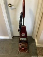 Full front view of upright carpet cleaner showing entire unit
