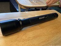 Left-side view of Coast HP650 flashlight on table