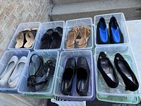 Overview of eight shoe pairs in individual clear bins on step