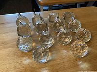 Group of fourteen faceted crystal balls on tabletop