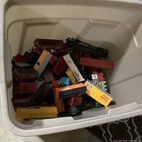 Plastic tote filled with numerous HO scale train cars