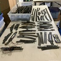 Overview of tote full of track and laid-out pieces