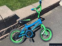 Left side view of the Nakamura Adventure kids bicycle showing full frame, wheels and chain guard
