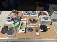 Overall view of Stihl trimmer heads, line and loose parts on table