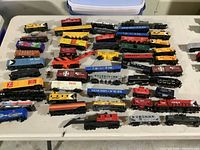 Overview of all locomotives and boxcars spread on table