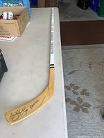 Full view of signed hockey stick on table