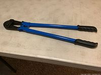 Full view of 24 inch blue bolt cutter on table