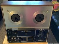 Front view showing entire Sony TC-377 deck, reel hubs, control panel
