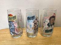Three glasses front view displaying different character graphics