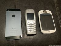 Rear view of Apple iPhone 5, front view Nokia 6610, front view HTC Touch
