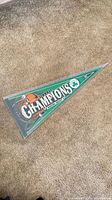 Full view of triangular Celtics Champions felt pennant