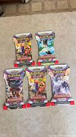 Front view of five Paldea Evolved sleeved booster packs