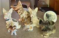 Front view showing all seven porcelain terrier items