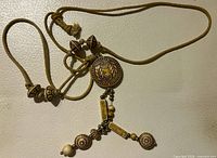 Overall view of silk cord necklace showing pendant, beads and adjustable knot