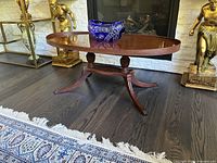 Full view of oval coffee table in front of fireplace
