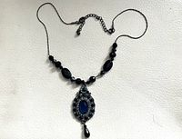 Full view of necklace showing beads, pendant, extender chain