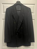 Front view of black double-breasted blazer on hanger