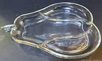 top view of clear glass 3-section divided dish with handle