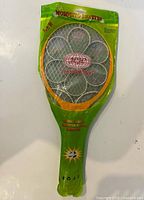Front of packaged mosquito swatter showing brand, orange frame and green packaging