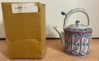 Teapot next to original cardboard box