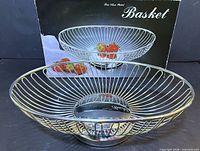 silver plated wire basket displayed in front of original box