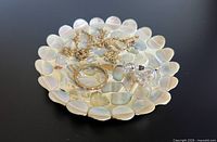 Top view of mother of pearl trinket dish with jewelry props